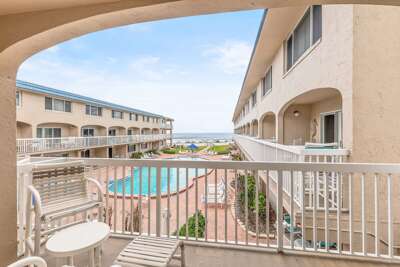 Relax on your private balcony overlooking the resort-style pool with partial ocean views. This beach stay offers easy beach access, coastal breezes, and the perfect spot for your seaside getaway.