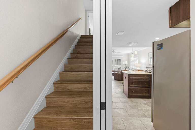 Step into this inviting beach stay featuring stylish coastal interiors, wood stairs, and an open-concept living space designed for comfort and relaxation during your seaside getaway.