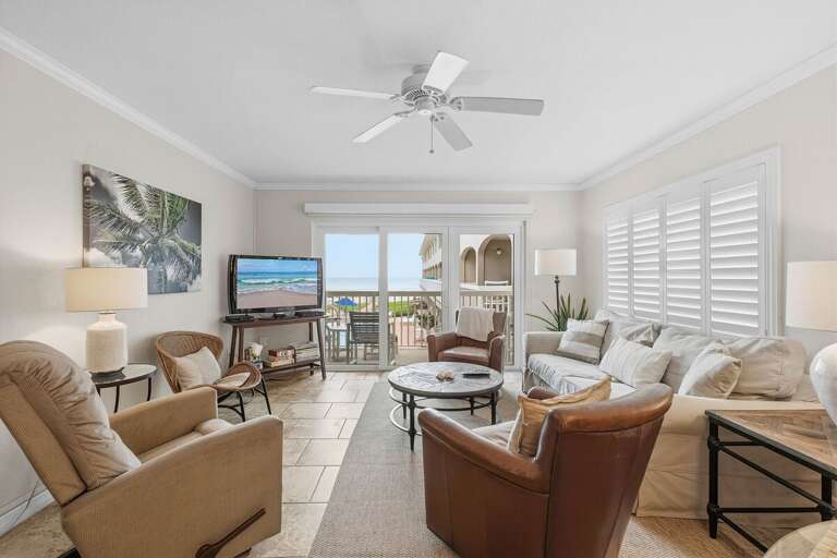 Unwind in this bright beach condo featuring cozy coastal décor, comfortable seating, and balcony access with ocean views. Perfect for a relaxing beach stay just steps from the sand and pool.