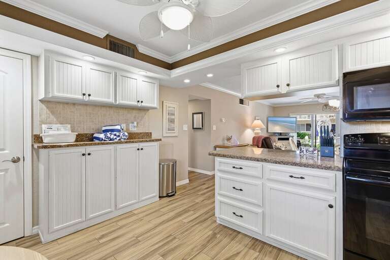Bright, open kitchen with ample storage, modern appliances, and breakfast bar. Perfect for your