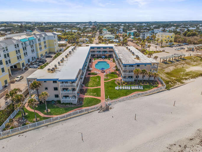 Enjoy a relaxing beach stay at this oceanfront condo featuring a private pool courtyard, lush lawn,