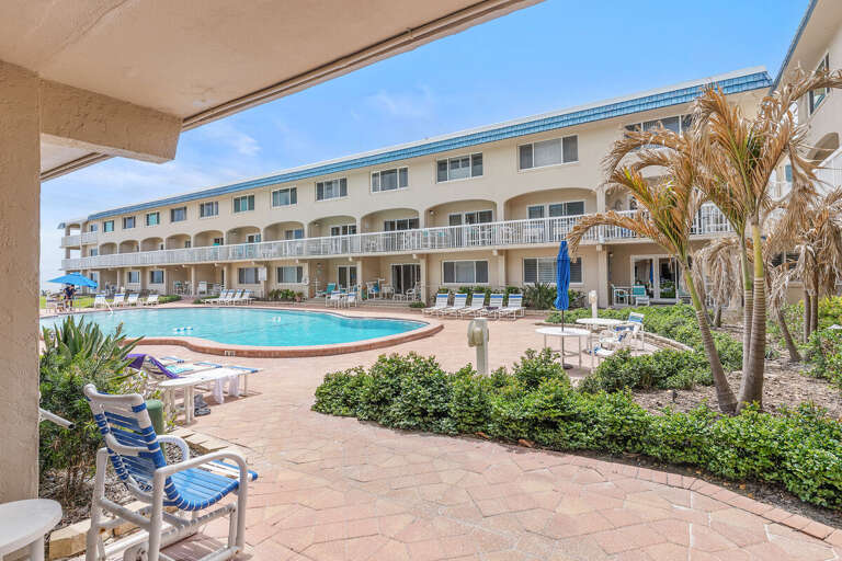 Enjoy your beach stay with this spacious resort-style pool, lounge chairs, and tropical surroundings. Relax poolside or soak up the sun just steps from your vacation rental and the nearby ocean.