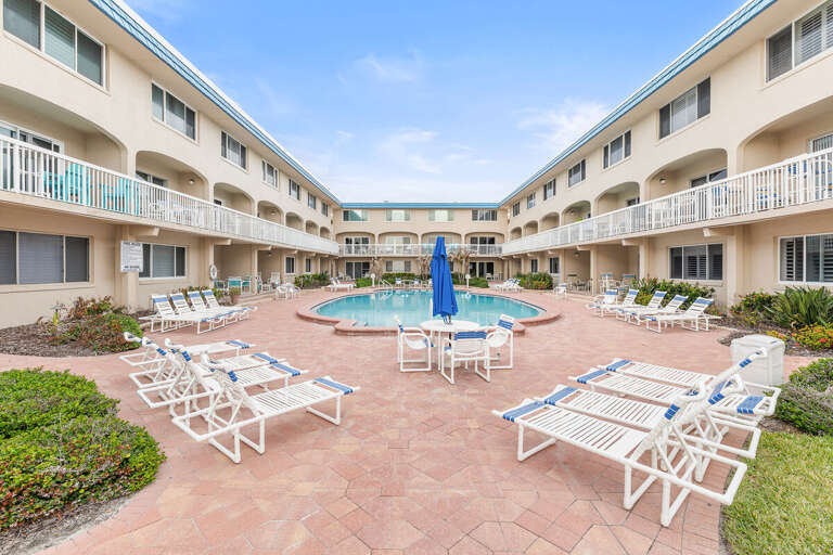Relax in this inviting courtyard pool area with plenty of lounge seating and sunny space. Ideal for
