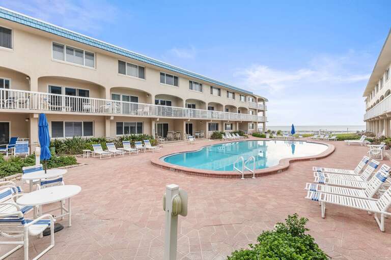 Relax poolside on this expansive sun deck with plenty of lounge seating and ocean nearby. Perfect for your beach stay, enjoy sunny days, refreshing swims, and easy access to sand and surf.