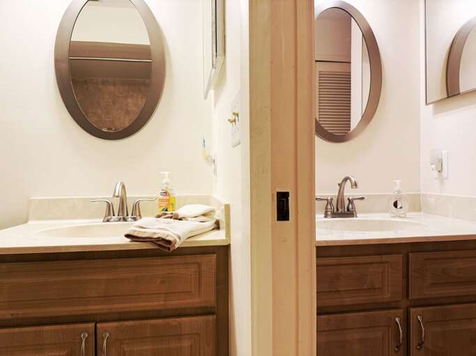 This beach stay rental features a dual vanity setup, perfect for couples or families. Spacious counters and modern fixtures make getting ready after a day by the shore simple and stress-free.