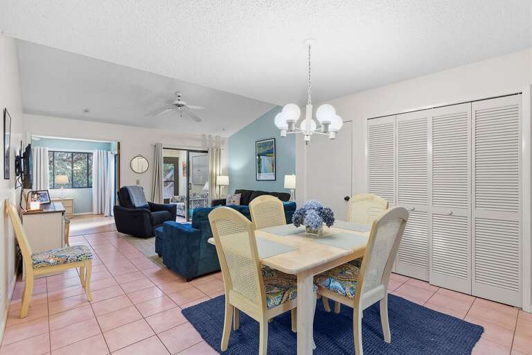 Enjoy meals and memories in this bright coastal dining area flowing into a comfortable living room
