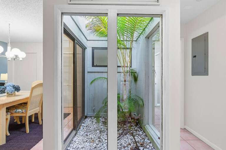 Enjoy tranquil views of a private tropical atrium that brings natural light and coastal charm indoors. This unique feature adds a peaceful touch to your relaxing and unforgettable beach stay getaway.