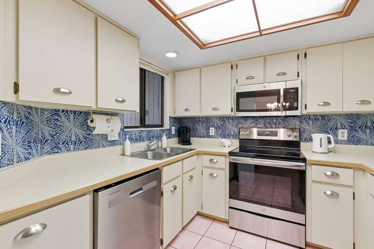 Prepare fresh meals in this bright, fully equipped kitchen featuring stainless steel appliances,