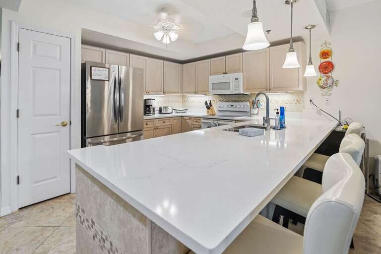 Cook in style in this bright, fully equipped kitchen featuring sleek stainless steel appliances, a Cook in style in this bright, fully equipped kitchen featuring sleek stainless steel appliances, a