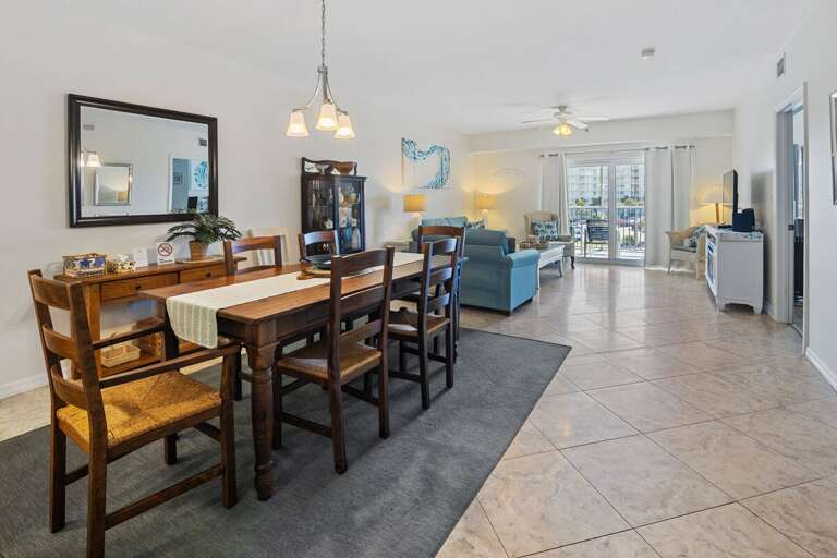 Enjoy family meals in this inviting dining area, just steps from the living room and balcony. Perfect for your beach stay, with plenty of space to relax after a sun-filled day by the shore.