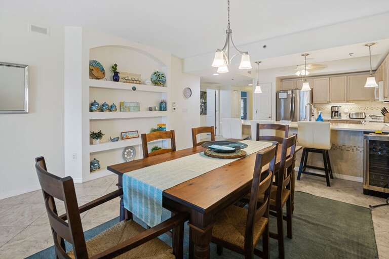 Gather for meals in this beach-inspired dining area, featuring charming coastal décor and an open flow to the modern kitchen—perfect for relaxing after a sunny day by the shore.