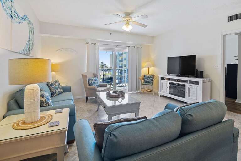 Unwind in this coastal-inspired living room with plush seating, natural light, and balcony access—perfect for enjoying ocean breezes and relaxing after a fun-filled day at the beach. Unwind in this coastal-inspired living room with plush seating, natural light, and balcony access—perfect for enjoying ocean breezes and relaxing after a fun-filled day at the beach.