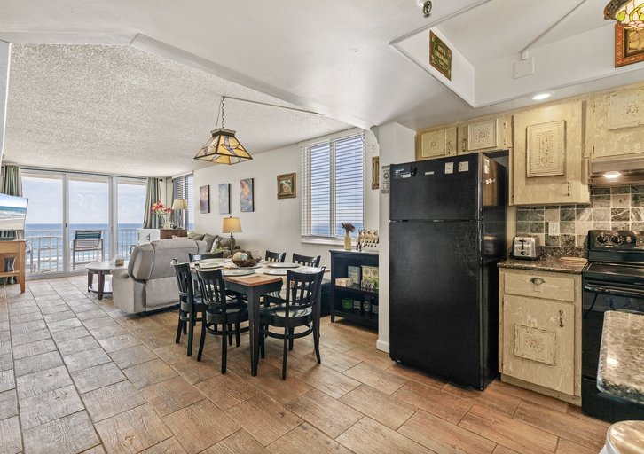 This open-concept beach condo features a full kitchen, dining space, and living area that flows to a balcony with stunning ocean views—perfect for a comfortable and memorable beach stay.