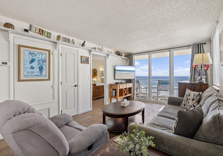 Unwind in this inviting beachfront living room featuring plush seating, a smart TV, and breathtaking ocean views from the balcony—perfect for your relaxing beach stay. Unwind in this inviting beachfront living room featuring plush seating, a smart TV, and breathtaking ocean views from the balcony—perfect for your relaxing beach stay.