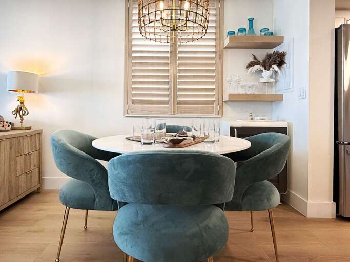 Enjoy meals in this stylish dining area with plush seating, elegant décor, and a warm coastal vibe—perfect for gathering after a day of beach adventures and seaside fun.