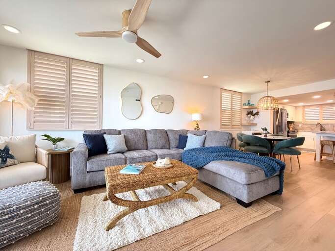 Relax in this bright and inviting living space featuring cozy seating, stylish décor, and an open layout—perfect for unwinding after a day at the beach or entertaining family and friends.