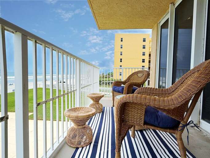 Relax on your private balcony overlooking the beach, complete with wicker seating and a breezy coastal vibe—perfect for enjoying morning coffee or evening sunsets by the ocean.