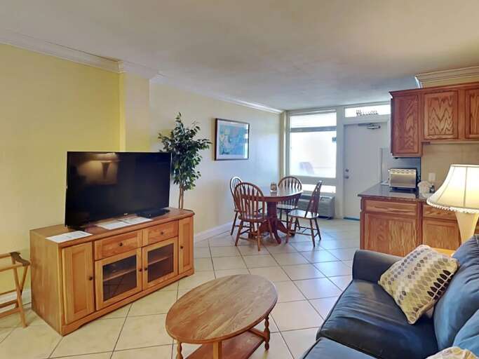 Relax in this inviting beach rental featuring a spacious living area, flat-screen TV, and dining Relax in this inviting beach rental featuring a spacious living area, flat-screen TV, and dining