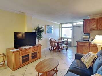 Relax in this inviting beach rental featuring a spacious living area, flat-screen TV, and dining Relax in this inviting beach rental featuring a spacious living area, flat-screen TV, and dining