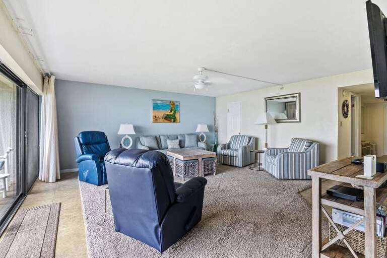 Enjoy a spacious living room with coastal décor, plush seating, and natural light. Perfect for