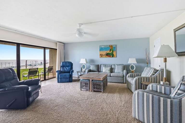 Relax in a bright and cozy living room with beach-inspired décor, plush seating, and direct access to ocean views—perfect for unwinding after a sun-filled day on your beach vacation. Relax in a bright and cozy living room with beach-inspired décor, plush seating, and direct access to ocean views—perfect for unwinding after a sun-filled day on your beach vacation.