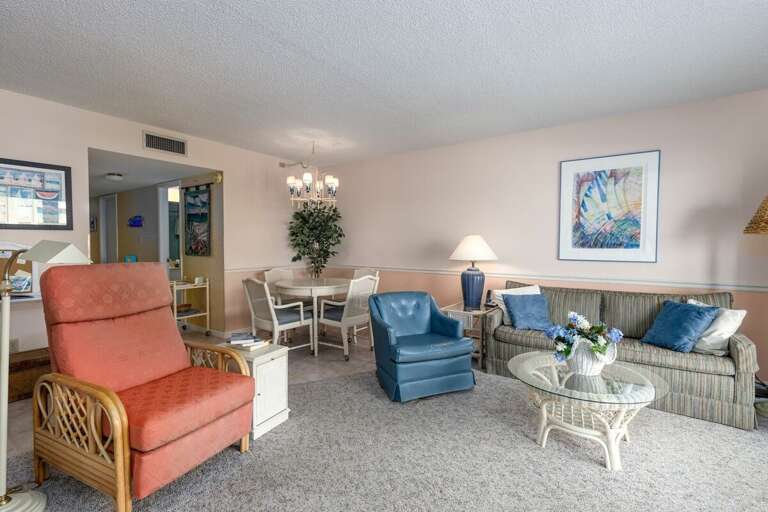 Relax after a day at the beach in this inviting coastal living area, featuring comfy seating, a dining nook, and charming seaside décor—perfect for unwinding during your oceanfront getaway. Relax after a day at the beach in this inviting coastal living area, featuring comfy seating, a dining nook, and charming seaside décor—perfect for unwinding during your oceanfront getaway.