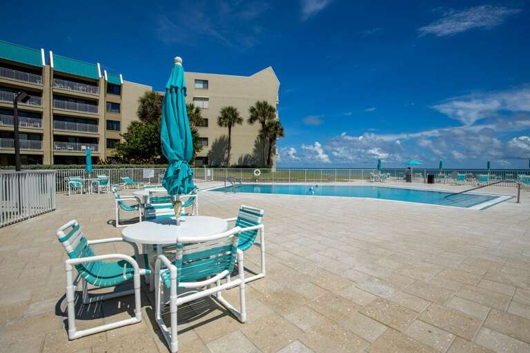 Soak up the sun during your beach stay on this oceanfront pool deck, featuring lounge chairs, shaded tables, and breathtaking views of the sparkling sea just steps away. Soak up the sun during your beach stay on this oceanfront pool deck, featuring lounge chairs, shaded tables, and breathtaking views of the sparkling sea just steps away.