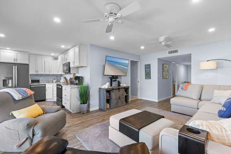 This bright beachside condo features an open layout with a modern kitchen, cozy seating, and coastal décor—perfect for relaxing after a day of sun and surf.