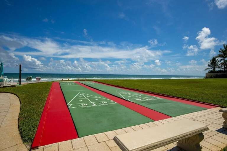 Play a round of shuffleboard just steps from the shore! This beachfront amenity offers fun for all ages with stunning ocean views, making it a perfect addition to your relaxing beach stay.