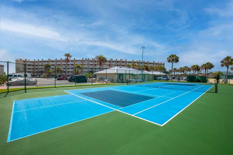Stay active during your beach stay with access to resort-style tennis courts surrounded by beautiful