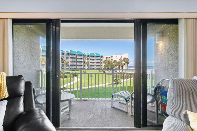 Step onto your private balcony and enjoy peaceful views of lush lawns and the sparkling ocean—perfect for sipping morning coffee or relaxing after a day at the beach.