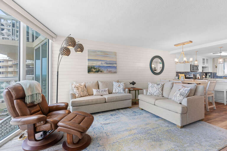 Bright and inviting beachside living space featuring coastal décor, plush seating, and ocean-inspired accents—perfect for relaxing after a day of sun and surf on your beachfront getaway.