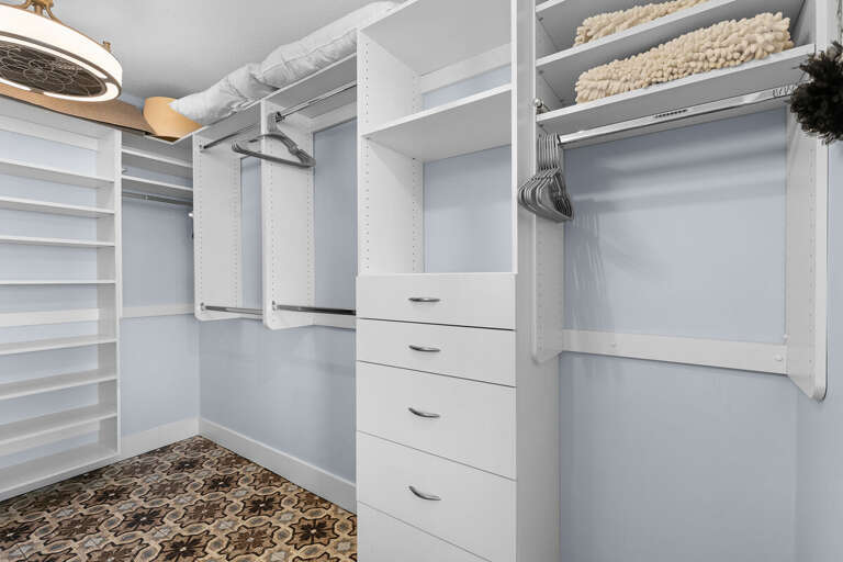 Enjoy a roomy beachside walk-in closet with built-in shelving and storage—perfect for keeping your seaside wardrobe organized during your coastal getaway.