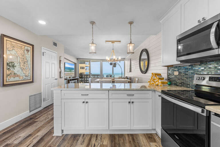 Enjoy stunning beach views from this open coastal kitchen and dining area. Bright, modern, and perfect for seaside gatherings after a sun-soaked day by the shore.