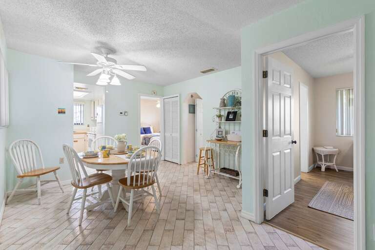 Enjoy seaside charm in this inviting dining space with beachy accents and natural light. Perfect for family meals or morning coffee before heading out to explore the sun, sand, and surf.