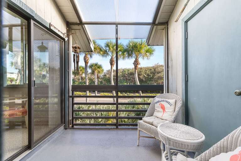 Unwind on this relaxing screened patio surrounded by palm trees and ocean breezes. Perfect for morning coffee or evening cocktails during your beachside escape.