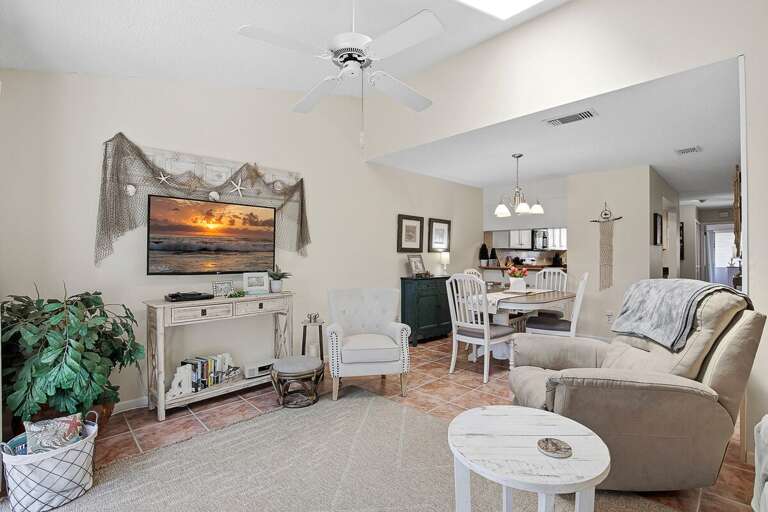 Bright beach stay with open living and dining space, cozy seating, and coastal decor throughout. Enjoy a relaxed, airy layout perfect for gathering and unwinding after a day at the beach.