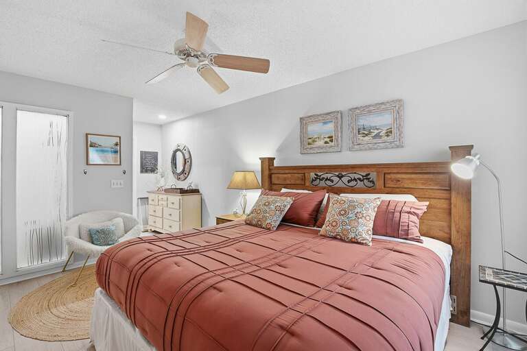 Comfortable beach stay bedroom featuring a plush bed, coastal decor, and soft lighting. A peaceful retreat designed for rest and relaxation after enjoying a day by the beach.