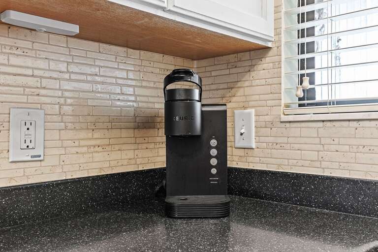 Convenient beach stay coffee station with Keurig machine, perfect for starting your day with fresh coffee before heading out to enjoy the sun, sand, and relaxing coastal vibes.