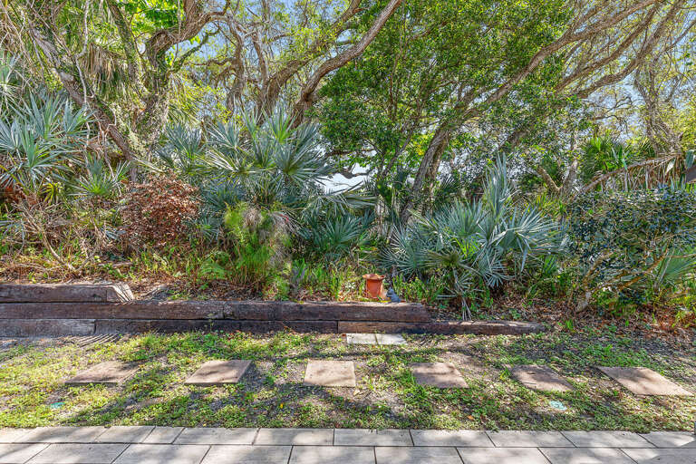 Immerse yourself in this beach stay's lush tropical garden, featuring native greenery and a peaceful