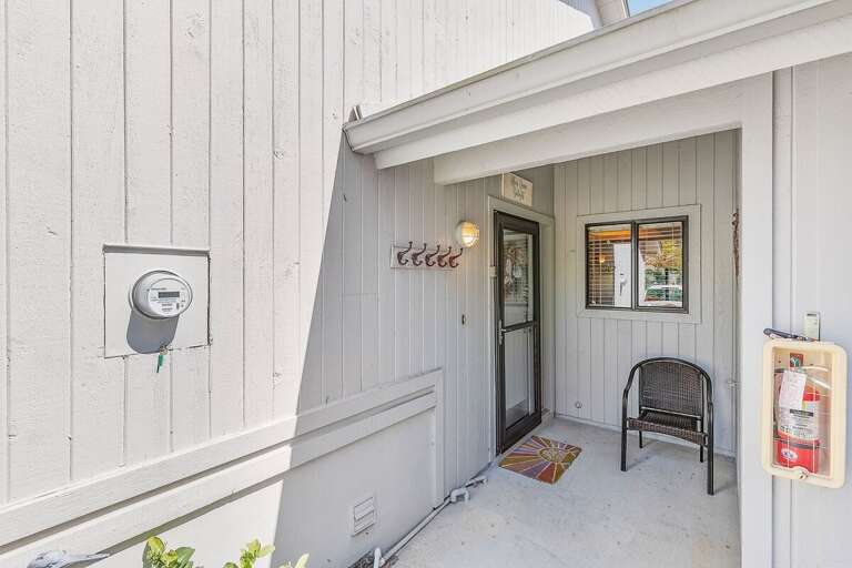Welcoming beach stay entry with covered patio, seating, and private access. A convenient and inviting arrival space to start your relaxing coastal getaway near the beach.