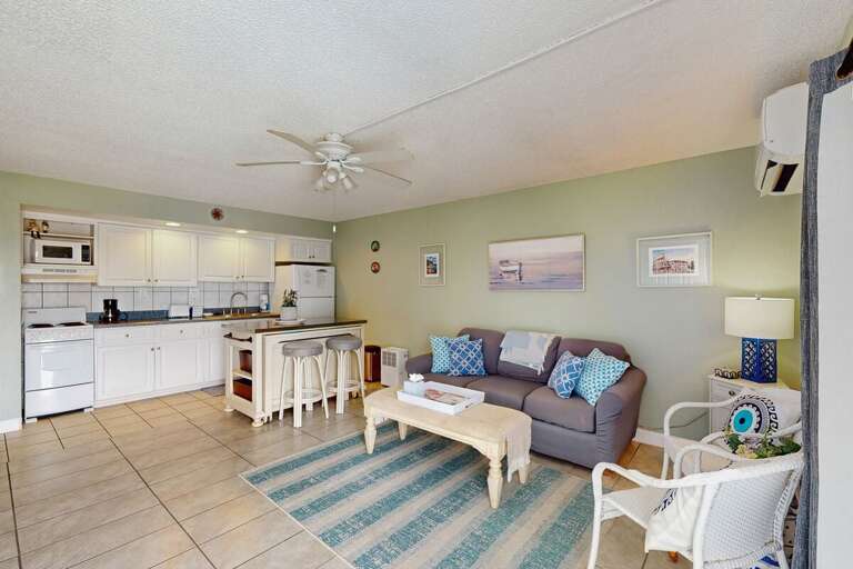 Bright Beach-themed Living Area With Striped Rug And Sea-inspired Decor