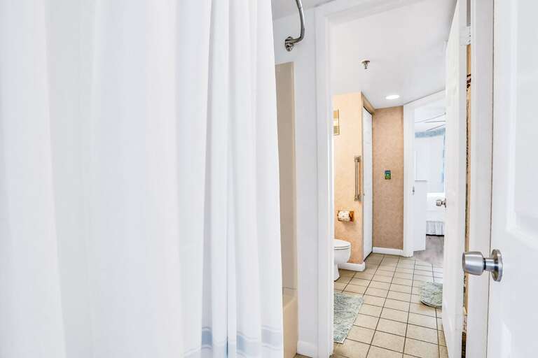 Indoor Passage Peering Into A Bright Bathroom