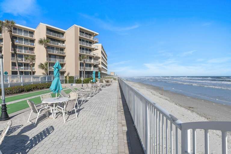 Relax on the spacious oceanfront sundeck with comfortable seating and beautiful views of the sandy shoreline. Enjoy refreshing sea breezes and easy access to the beach during your coastal beach stay.