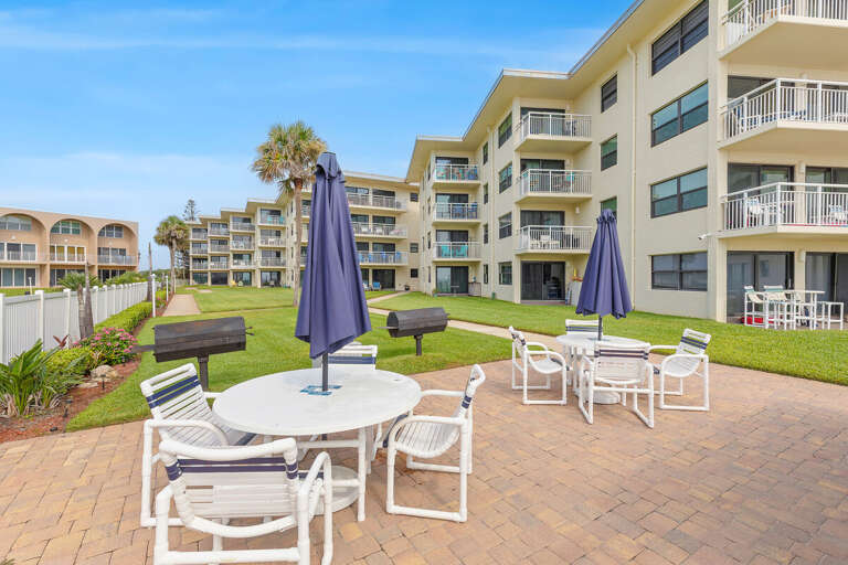 Enjoy outdoor dining with community BBQ grills, shaded picnic tables, and beautifully landscaped