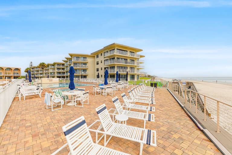 Relax on the spacious oceanfront pool deck with plenty of lounge seating, tables, and direct beach