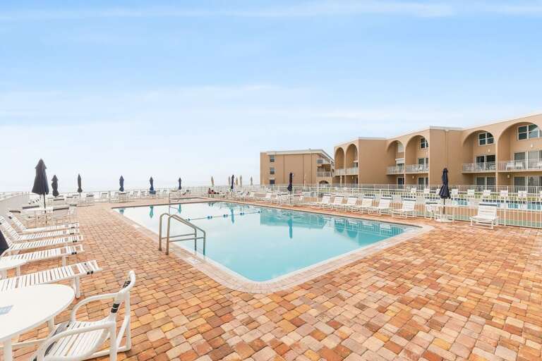 Unwind by the spacious oceanfront pool with plenty of lounge chairs and stunning coastal views.