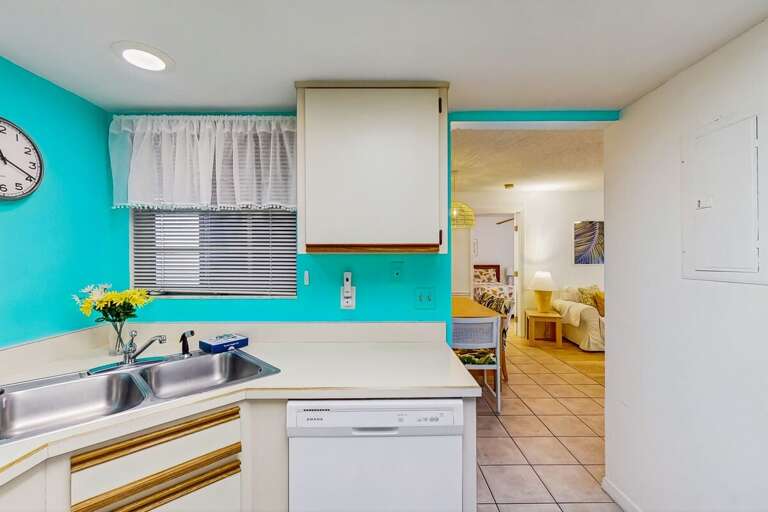 Bright Blue Kitchen Leading To Luminous Living Space