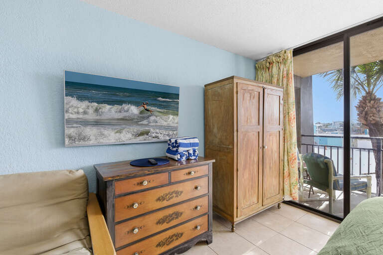 Bright beach stay studio featuring charming coastal décor, ample storage, and private balcony