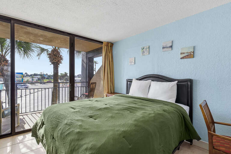 Wake up to palm views in this bright beach stay studio featuring a plush queen bed and private